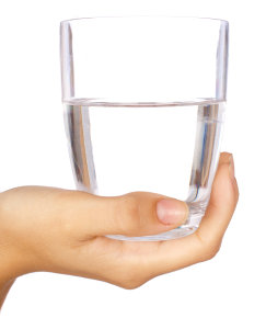 woman's hand holding glass of water