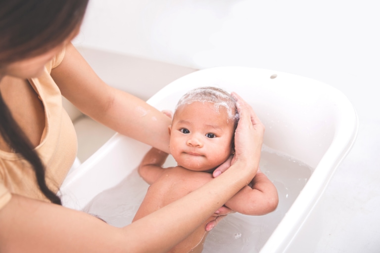 Woman bathing baby